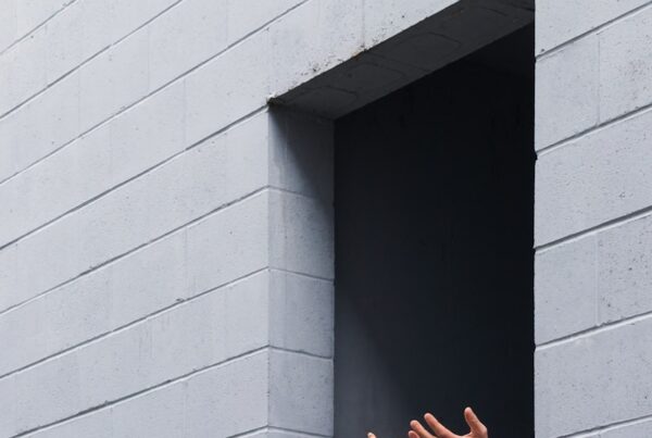 person standing on gray concrete wall