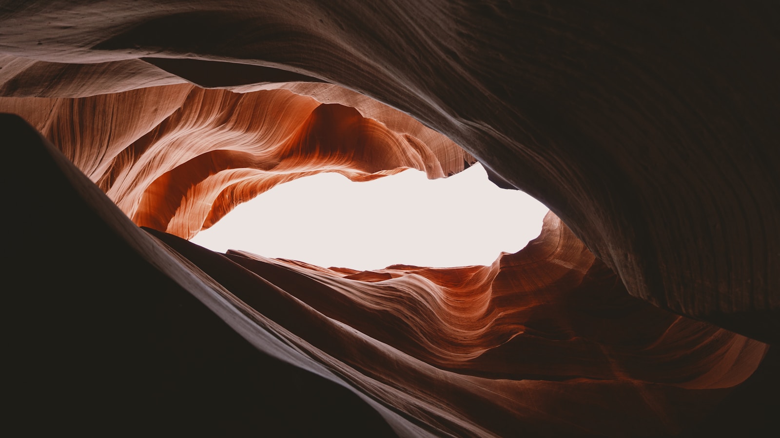 The light shines through a slot in the rock