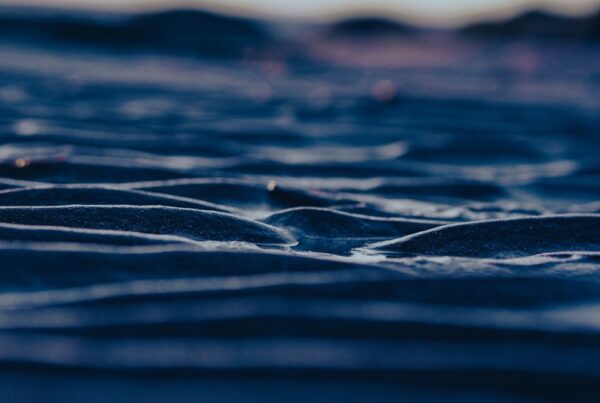 Rippled sand dunes under a twilight sky