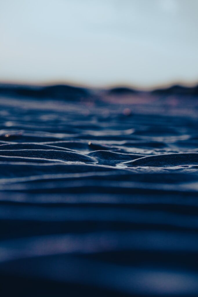 Rippled sand dunes under a twilight sky