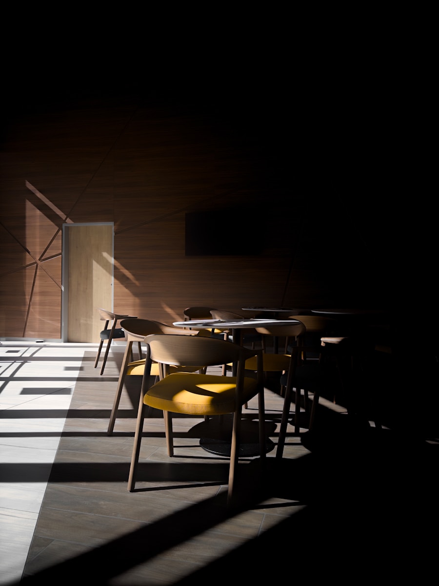 Chairs and tables in a room with dramatic light.
