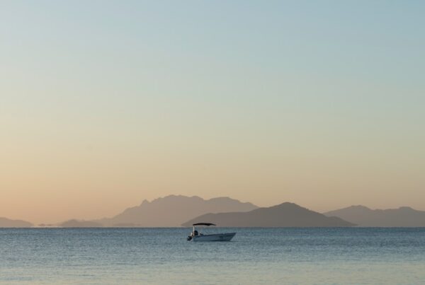 a small boat in the middle of a large body of water