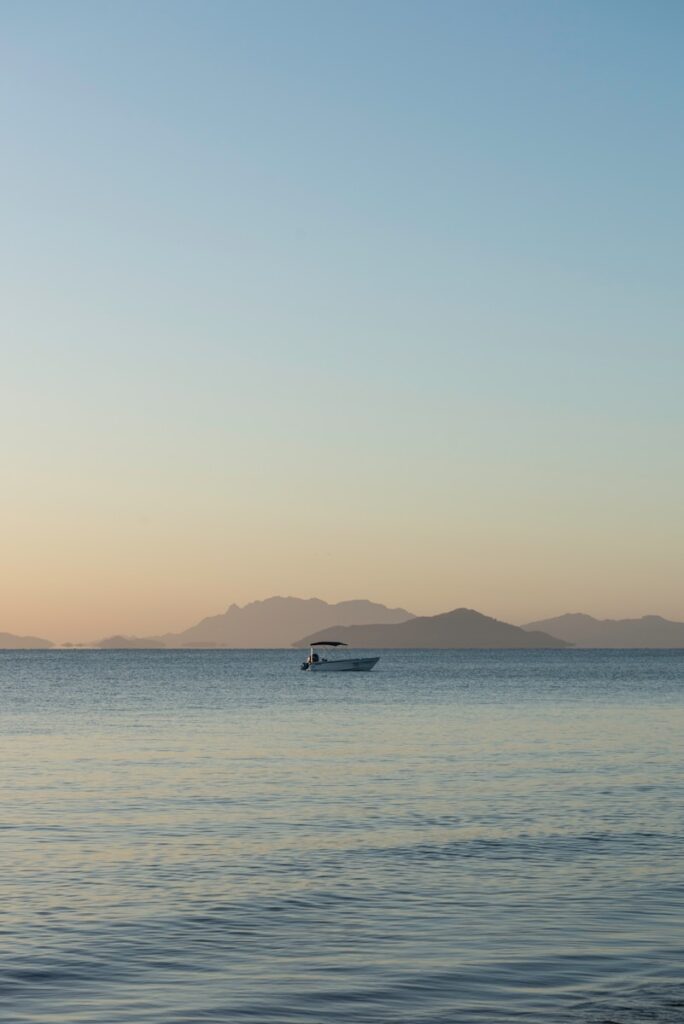 a small boat in the middle of a large body of water